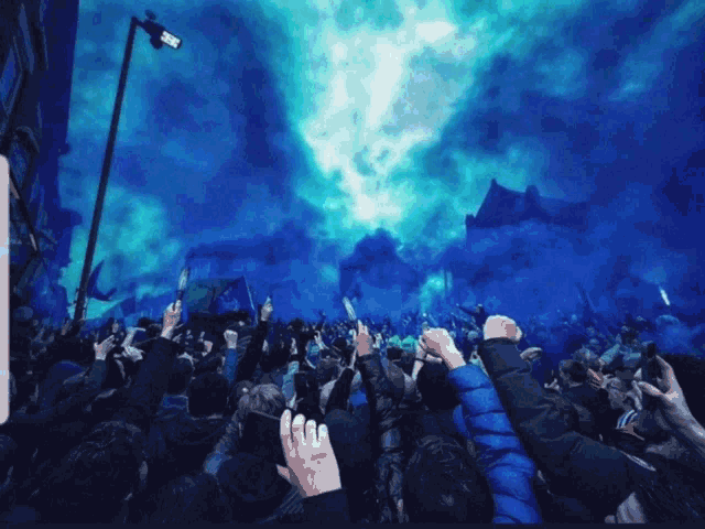a crowd of people holding up their fists in the air with blue smoke coming out of the sky