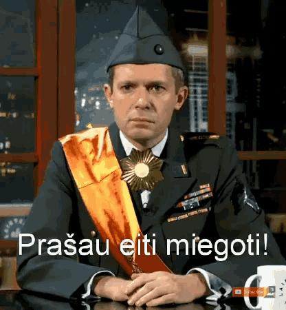 a man in a military uniform sits at a table with the words prasau eiti miegoti written on the bottom