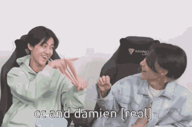 two young men are sitting next to each other and one of them says " cc and damien real "