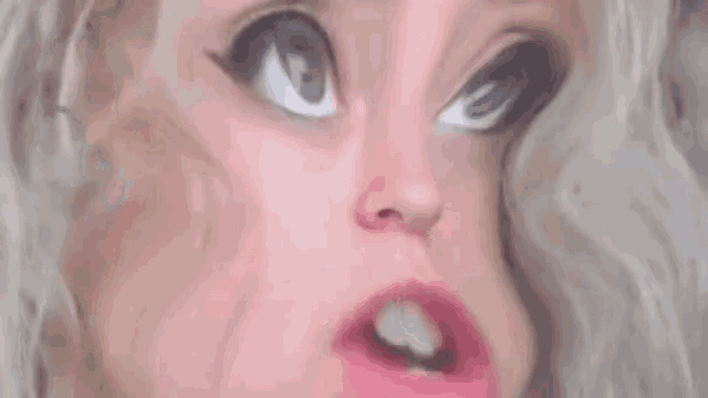 a close up of a woman 's face with a cartoon face .