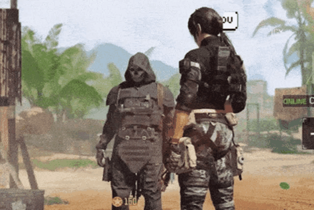 two soldiers are standing in front of a sign that says online c.