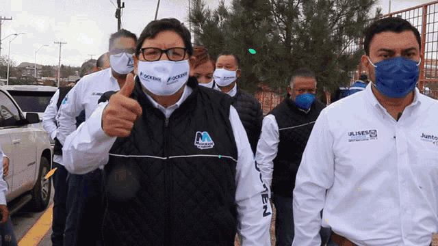a group of people wearing face masks and shirts that say junto