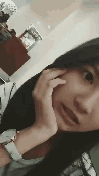 a woman is making a funny face in front of a sign that says ' asus '