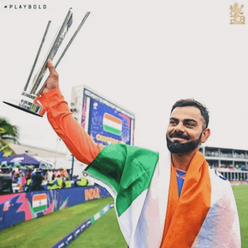 a man holding a trophy with the word playbold on the bottom right