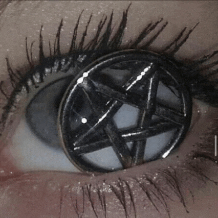 a close up of a person 's eye with pentagram contact lenses on it .