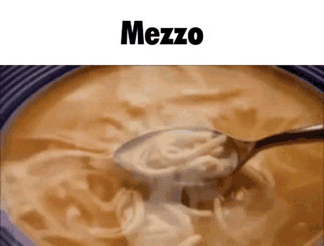 a bowl of soup with a spoon in it and the word mezzo on the top