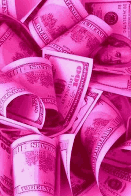 a pile of pink money stacked on top of each other .