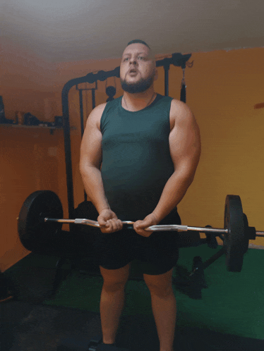 a man lifting a barbell in a gym