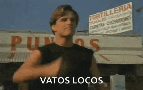 a man is standing in front of a restaurant with a sign that says tortilleria .