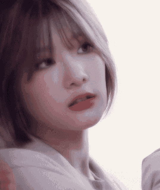 a close up of a woman 's face with a white background