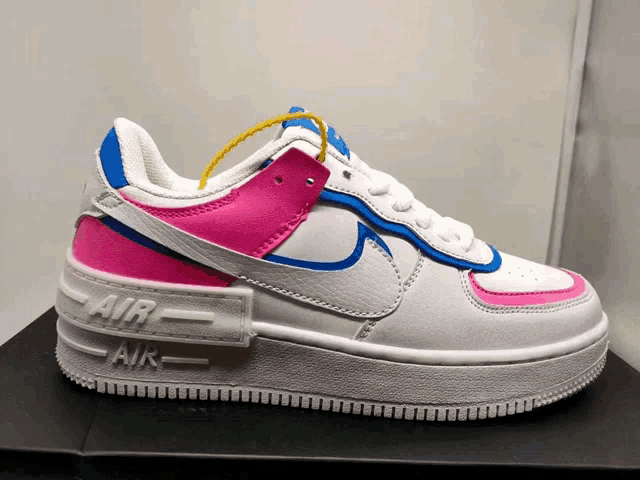 a pair of white and pink nike air force ones