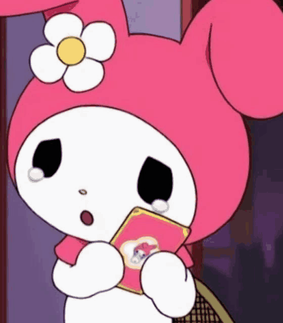 a pink and white cartoon character with a flower on her head is holding a card