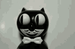a black and white cartoon cat with a bow tie