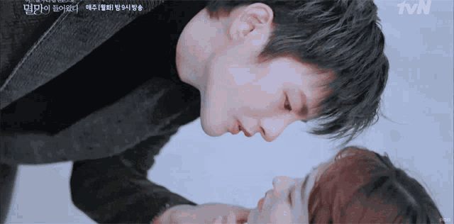 a man kissing a woman on the forehead with tvn written on the bottom