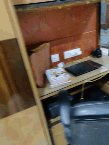 a blurred image of a desk with a monitor and a book on it