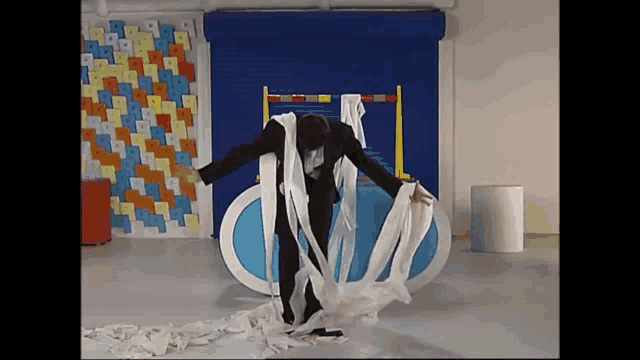 a man in a suit is surrounded by a large amount of toilet paper