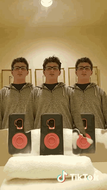 three boys are standing in front of a mirror with a tiktok watermark