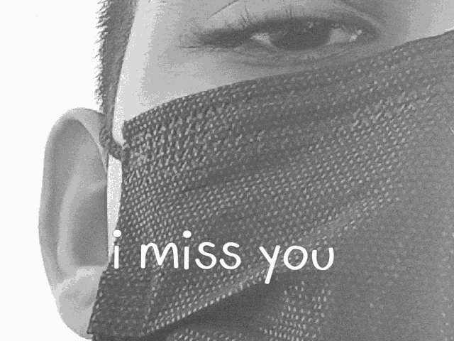 a black and white photo of a person wearing a face mask with the words i miss you written on it