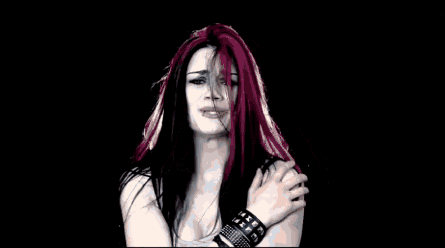 a woman with red hair is crying and making a face