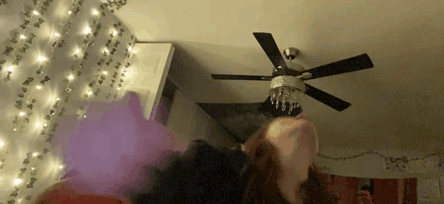 a ceiling fan is hanging from the ceiling in a dark room