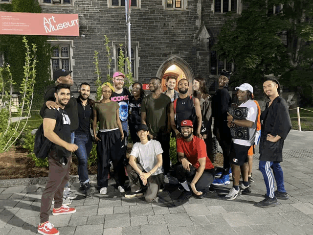 a group of people posing for a picture in front of a sign that says art museum