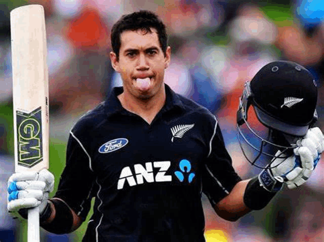 a cricket player is holding a bat and a helmet .