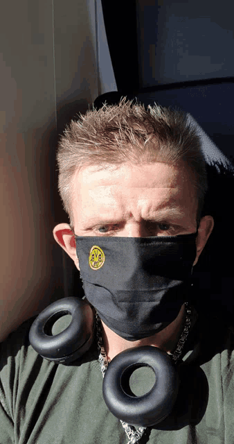 a man wearing a face mask with bvb embroidered on it