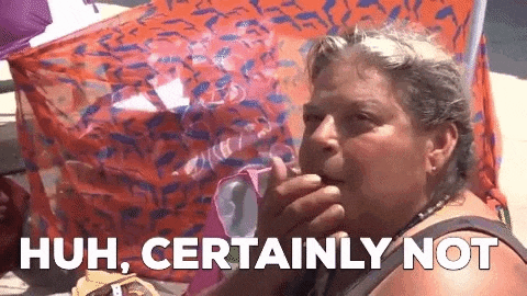 a woman is smoking a cigarette and says `` huh , certainly not '' while sitting on a beach .