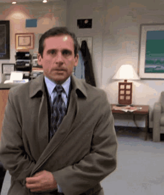 a man in a suit and tie standing in a room