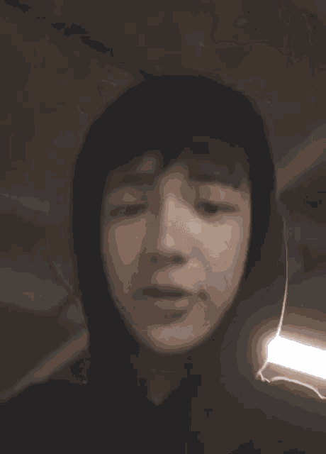 a close up of a person 's face with a tear coming out of it .