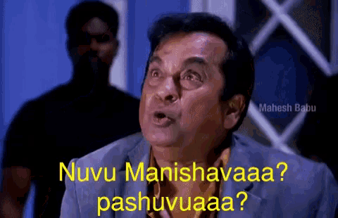 a man in a suit says nuvu manihavaaa pashuvuaa