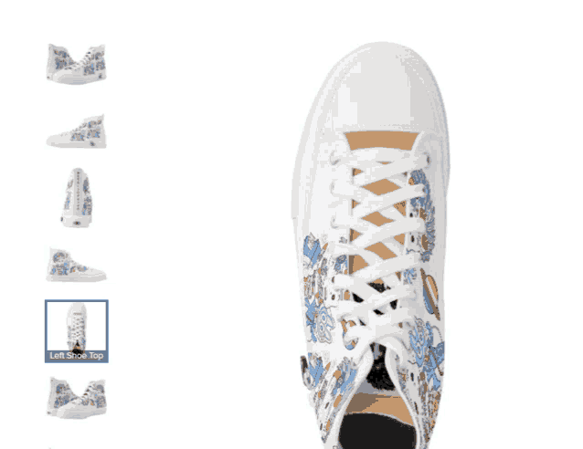 a pair of white high top sneakers with a butterfly design on the side