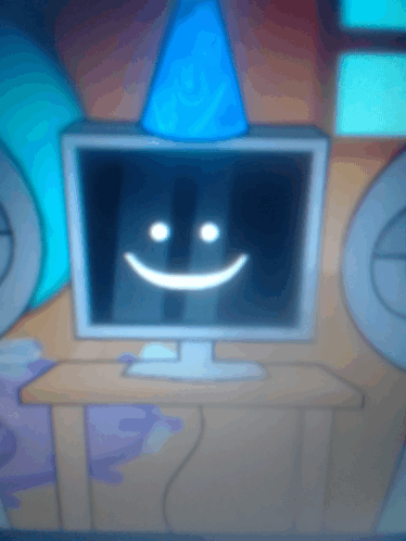 a computer monitor with a smiley face and a party hat on it