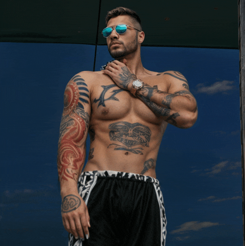 a man with a lot of tattoos on his torso and arms