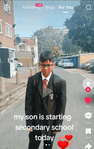 a boy in a suit and tie is standing on a street with the words " my son is starting secondary school today " below him