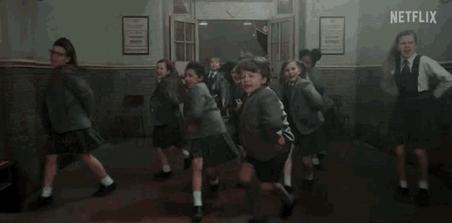 a group of children are dancing in a hallway and the caption says me when the #matilda sweep happens