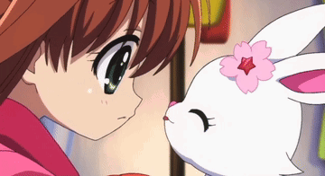 a girl and a white rabbit with a pink flower on its head