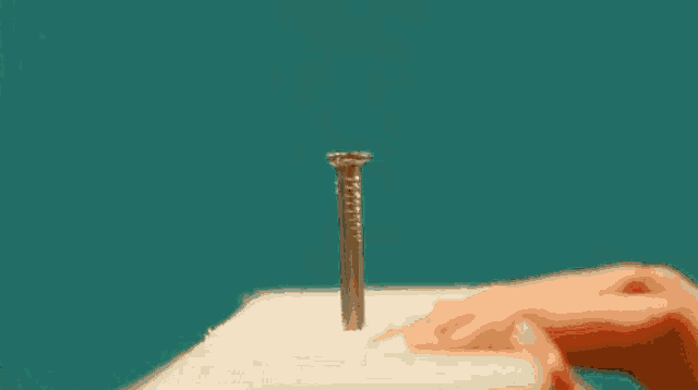 a woman in a pink bikini is holding a hammer on a workbench