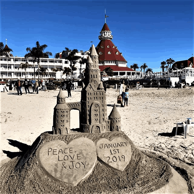 a sand castle with the words peace love and joy