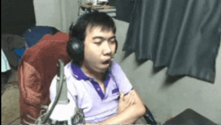 a man wearing headphones sitting in front of a computer