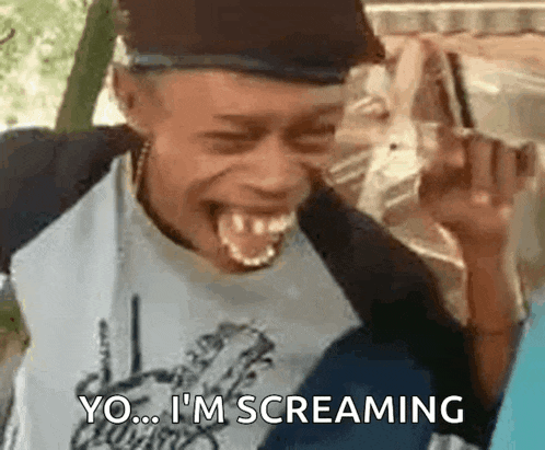 a man is screaming with his mouth open and his tongue hanging out .