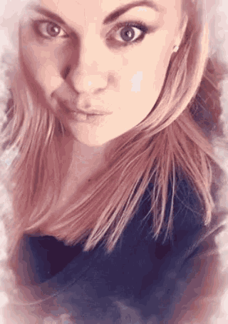 a close up of a woman 's face with a black shirt on