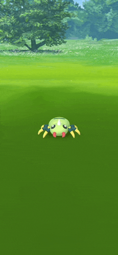 a green spider is sitting on top of a green field in a video game .