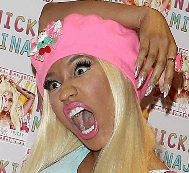 a blonde woman wearing a pink hat with a bow on it