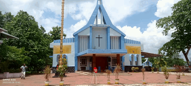 a blue building with a cross on the front of it