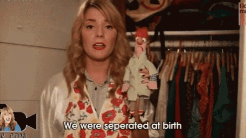 a woman is holding a puppet and says we were separated at birth