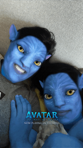 a man and a woman with blue faces and the word avatar on the bottom