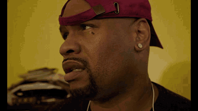 a close up of a man wearing a pink hat