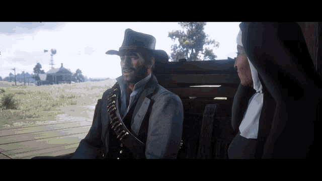 a man in a cowboy hat stands next to a nun