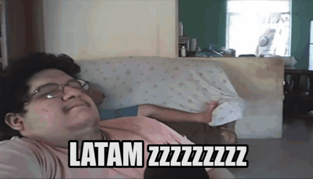 a man laying on a couch with the words latam zzzzzzz on the bottom of his shirt